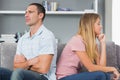 Couple sitting back to back after a fight on the couch Royalty Free Stock Photo