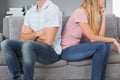 Couple sitting back to back after a fight on the sofa Royalty Free Stock Photo