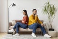 Couple Sitting Back To Back To Each Other On Couch At Home Royalty Free Stock Photo