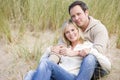 Couple sitting on beach smiling Royalty Free Stock Photo