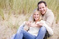 Couple sitting on beach smiling Royalty Free Stock Photo