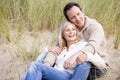 Couple sitting on beach smiling Royalty Free Stock Photo