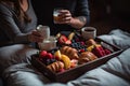 A couple sitting in bed with a tray of breakfast. Generative Ai Royalty Free Stock Photo