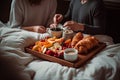 A couple sitting in bed with a tray of breakfast. Generative Ai Royalty Free Stock Photo
