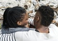 Couple sitting by the bonfire ashes