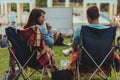 couple sitting in camp-chairs in city park looking movie outdoors at open air cinema Royalty Free Stock Photo