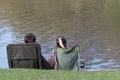 Couple sitting on camping chair outdoors