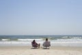 A couple sitting on canvas chairs