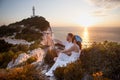 couple sitting on the cliff shooting on drone
