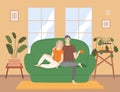 Couple sitting on the couch at home in the living room interior near big window, drinking tea Royalty Free Stock Photo