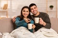 Couple sitting on couch and watching TV Royalty Free Stock Photo