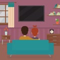 Couple sitting on couch watching tv