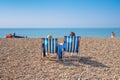 Couple sitting in deckchairs on a beach. Royalty Free Stock Photo