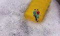 Couple sitting on the dock by a dishwasher sponge