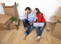 couple sitting on floor moving in a new house or apartment flat Royalty Free Stock Photo