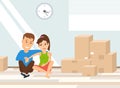 Couple sitting on the floor near the cardboard boxes.moving day concept