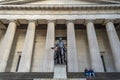 A Couple is Sitting in Front of Federal Hall Building in Wall Street. Greek Style Building in Manhattan, New York City