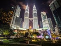 Couple sitting in front of the Petronas Towers and KLCC at Christmas Time