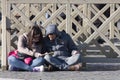 Couple sitting on the ground with a city guide