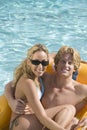 Couple Sitting In An Inflatable Raft In Pool Royalty Free Stock Photo