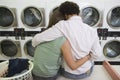 Couple Sitting At Launderette