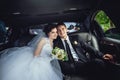 The couple sitting in the limo. Portrait of a beautiful young couple who rides around the city Royalty Free Stock Photo