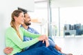 Couple sitting on living room floor enjoying view