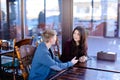 Couple sitting in luncheonette holding hands and discussing new Royalty Free Stock Photo