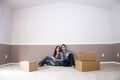 couple sitting in new home on moving day