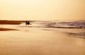 Couple sitting on the ocean watching the sunset Royalty Free Stock Photo