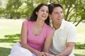 Couple sitting outdoors smiling Royalty Free Stock Photo