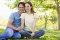 Couple sitting outdoors smiling Royalty Free Stock Photo