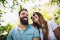 Couple sitting on the park bench and blowing soup bubbles