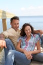 Couple sitting on a pontoon Royalty Free Stock Photo