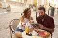 Couple sitting and reading guidebook in coffee shop, Ibiza, Spain