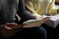 Couple sitting and reading holy Bibles, closeup