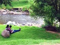 Couple sitting on River Bank of Rio Tomebamba in Cuenca, Ecuador