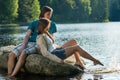 Couple sitting on rock sharing romantic moment