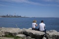 Couple sitting on the rock with views of Toronto cityscape