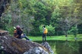 Couple sitting on rocks and taking pictures nature, flowers. at Paphiopedilum orchid conservation center Royalty Free Stock Photo