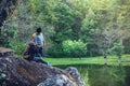 Couple sitting on rocks and taking pictures nature, flowers. at Paphiopedilum orchid conservation center Royalty Free Stock Photo