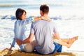 Couple Sitting on Sand at the Beach looking the sea Royalty Free Stock Photo