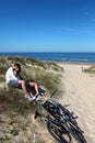 Couple sitting on sandy dune embracing