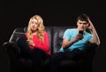 A couple sitting separately with smartphones Royalty Free Stock Photo