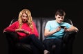 A couple sitting separately with smartphones