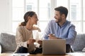 Couple sitting on sofa busy with manage household budget