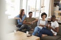 Couple Sitting On Sofa With Friends At Home Talking Royalty Free Stock Photo