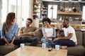 Couple Sitting On Sofa With Friends At Home Talking Royalty Free Stock Photo