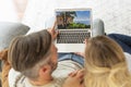 Couple sitting on the sofa at home and using laptop Royalty Free Stock Photo
