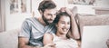 Couple sitting on sofa and using laptop Royalty Free Stock Photo